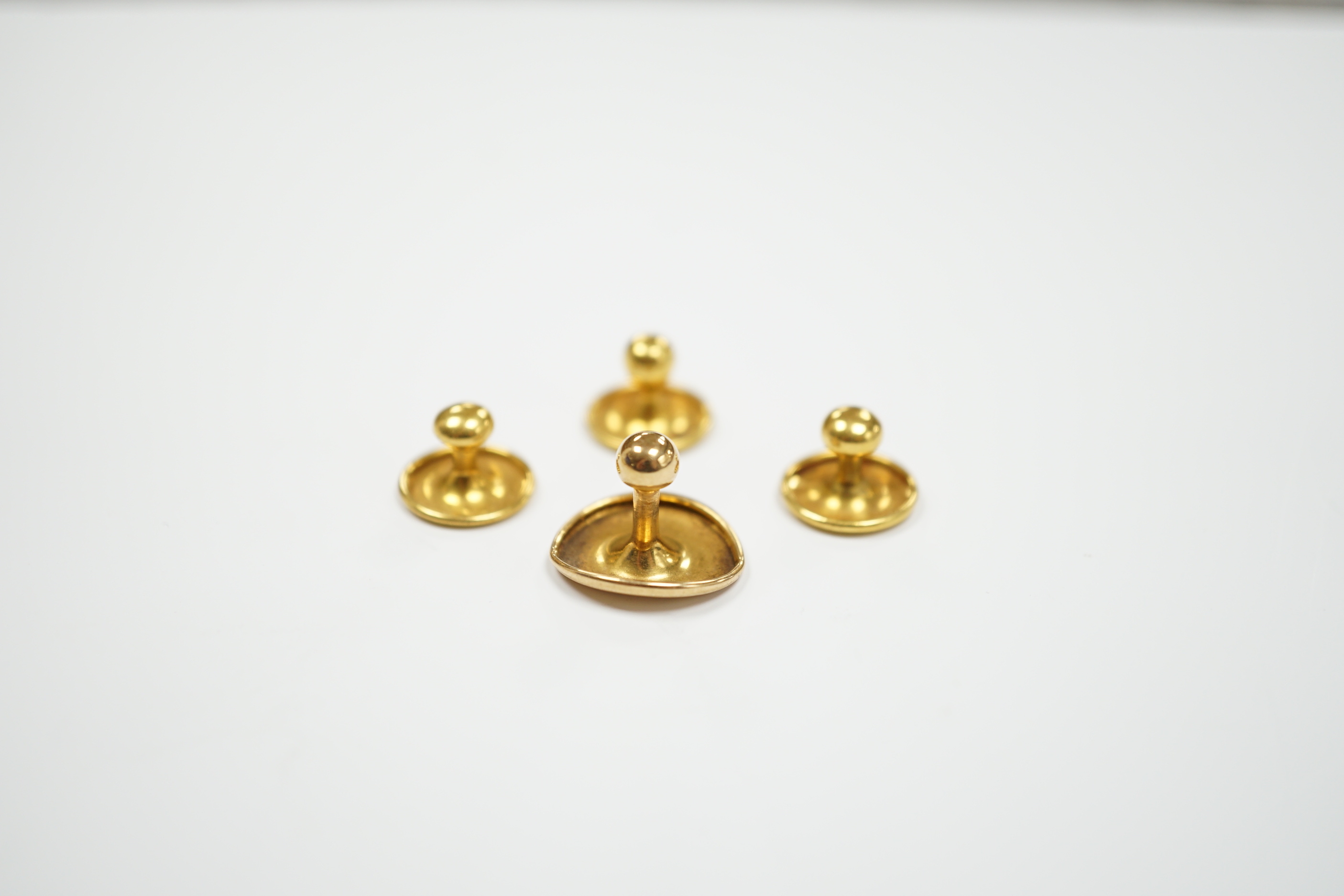 Four 18ct dress studs, 3.3 grams.